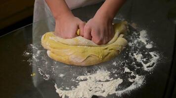 Close up view of bakers hands kneading the dough on the table. video