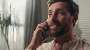 Close up man Caucasian male homeowner talking mobile phone on sofa casual conversation smiling positive happy guy call smartphone communicate friendly chatting cellphone order food delivery at home video