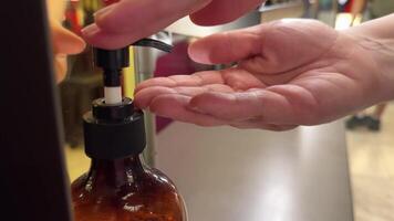 The correct way to use a dispenser. The girl uses a dispenser in the bathroom. Camera video