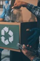 A man is holding a box with recycling symbols on it photo