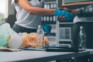 Two people shaking hands over a table with garbage and bottles photo