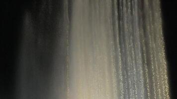 Waterfall Illumination Night Photography. Cascading water illuminated at night, showcasing its texture and flow. video