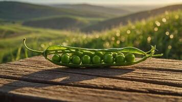 A fresh pea pod with green peas resting on a wooden surface, set against a scenic landscape. photo