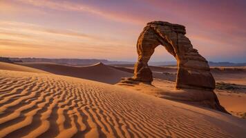 A stunning desert landscape featuring a natural stone arch at sunset. photo