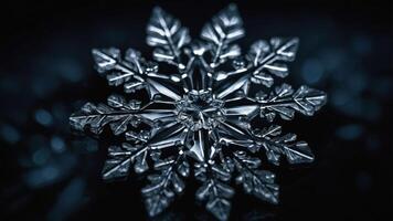 A close-up of a detailed snowflake against a dark background, showcasing its intricate structure. photo