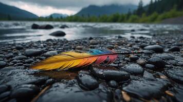 A colorful feather rests on wet stones by a serene river, surrounded by a misty landscape. photo