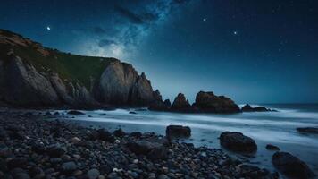 A serene coastal scene under a starry night sky with rocky formations and gentle waves. photo