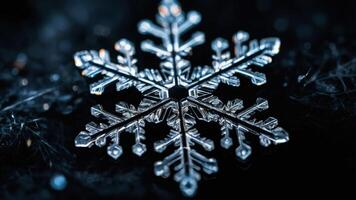A close-up of a delicate snowflake against a dark background, showcasing its intricate patterns. photo