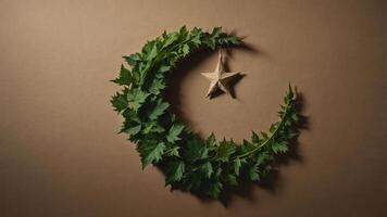 A crescent moon made of leaves with a star, symbolizing nature and celebration. photo