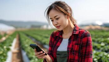 Beautiful Asian Woman Using Smartphone in Farm Setting with Background Copyspace photo