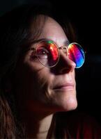 Candid portrait of a woman with colorful sunglasses indoor setting emotional expression upward view photography concept photo