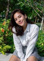 Smiling woman in nature lifestyle portrait outdoor setting bright green environment photo