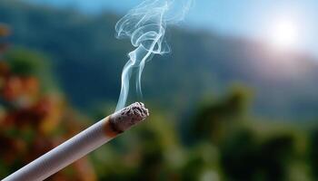 Smoky cigarette relaxation moment lush green background close-up photography natural setting calm atmosphere photo