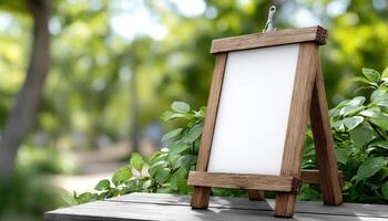 Displaying a blank canvas on a wooden easel amidst a lush green garden photo
