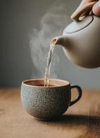 Pouring hot tea into a cozy mug home setting lifestyle photography minimalist aesthetic photo