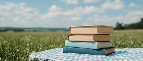 Reading and relaxing in a sunny field with books outdoor lifestyle tranquil nature photo