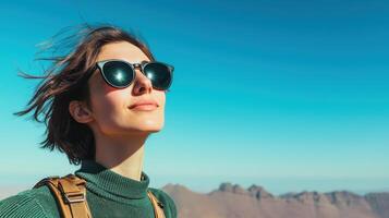 Inspiring travel adventure mountain top lifestyle portrait clear blue sky upbeat perspective photo