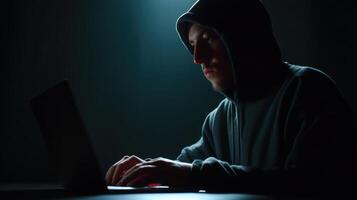 Cyber intrusion scene hacker in dark hoodie home office digital environment close-up view security awareness photo