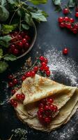 A Stack of Golden Crepes with Red Currants photo