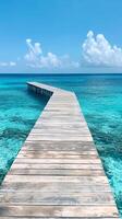 Peaceful wooden pier stretching into blue waters photo