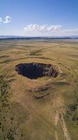 Stunning Aerial View of a Dramatic Crater in the Desert Landscape photo