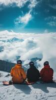 Snowboarders Enjoying the View from a Snowy Mountain Peak photo
