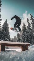 Snowboarder Jumping Over Bench in Snowy Mountains photo