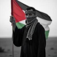 A man in black and white holding a palestinian flag photo