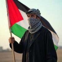 Palestinian man holding a palestinian flag photo