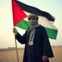 Palestinian man holding palestine flag in desert photo
