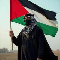 A man in a black mask and black robe holding a palestinian flag photo