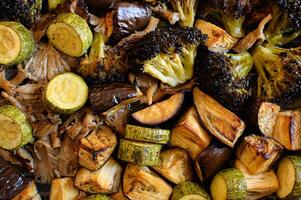 A healthy mix of roasted broccoli, zucchini, mushrooms, and eggplant, with a crispy outer layer and tender inside. photo