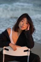 Profile portrait with intense expression, sharp suit lines highlighted against the backdrop of waves. photo