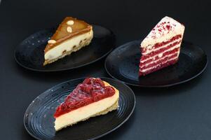 Elegant slices of cherry and caramel cheesecake with a red velvet cake, styled on a dark background with rich lighting. photo