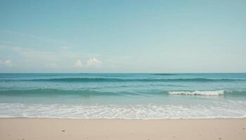 Serene Ocean Waves Gently Lapping on Sandy Beach Under Clear Sky photo