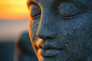 A stone statue of a buddha with its eyes closed photo