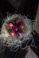 Traditional Ukrainian Easter eggs Pysanka in black, red and white colors on a dark background. photo