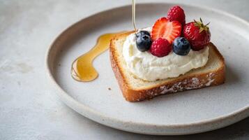 A single slice of toast farm bread with organic cream cheese and fresh summer berries. photo