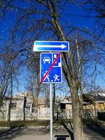 Kyiv, Ukraine - April 11, 2025 Street photo of blue traffic sign indicating end of residential zone. Taken on clear sunny day with trees and houses in background. End of residential zone road sign