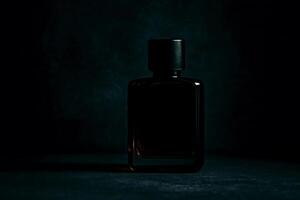 Elegant black perfume bottle in dark moody lighting on textured background with luxurious and mysterious atmosphere photo