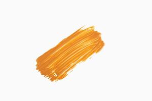 Wide orange paintbrush stroke on clean white background. Perfect for creative design projects, abstract art themes, product presentations or textured compositions. Orange brush stroke on white photo