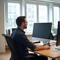 Professional Man Working On Computer In Modern Office Environment During Daytime photo