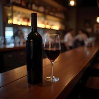 Elegant Red Wine Bottle And Glass At The Bar With Soft Lighting photo