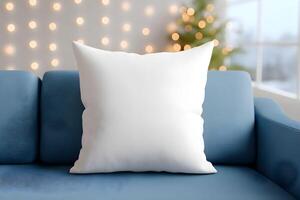 Cozy living room features a plush white pillow for mockup on a soft blue couch with warm holiday lights in the background, capturing a festive atmosphere photo