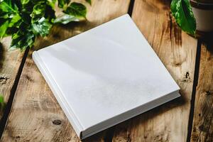 Blank notebook for mockup resting on a rustic wooden table surrounded by vibrant green plants creating a serene workspace atmosphere photo