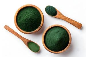 Dark green spirulina powder displayed in wooden bowls and spoons, highlighting its texture and vibrant color for a health-focused presentation photo