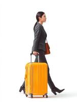 professional Asian businesswoman walking in profile, carrying yellow suitcase and brown handbag, exuding confidence and style photo