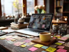 creative workspace featuring laptop, cup of coffee, and colorful sticky notes scattered across wooden table. warm ambiance invites productivity and inspiration photo