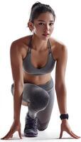 Asian female runner in starting pose, showcasing athletic build and determination, ready to sprint. image captures essence of fitness and motivation photo