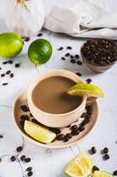A cup of latte infused with lime on the table vertical view photo